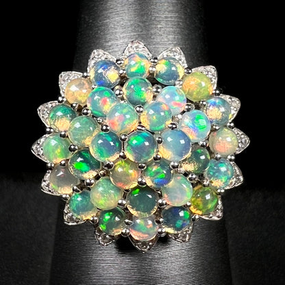 A sterling silver cluster flower ring mounted with 33 round Ethiopian fire opals.