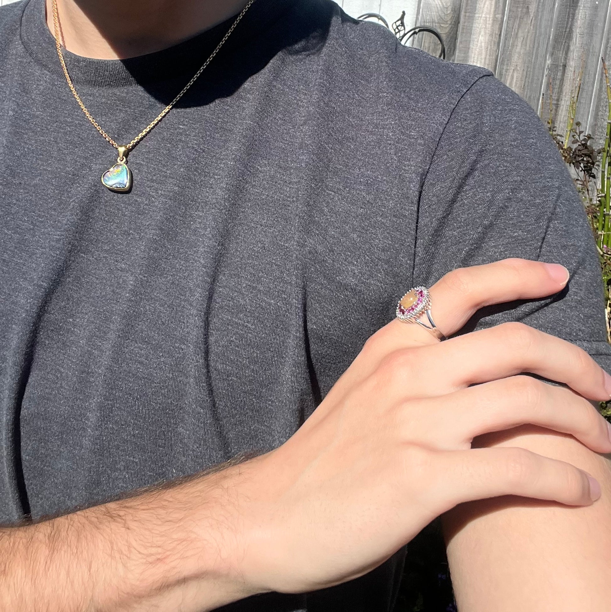 A sterling silver Ethiopian opal ring mounted with a halo of white CZs and another halo of synthetic pink sapphires.