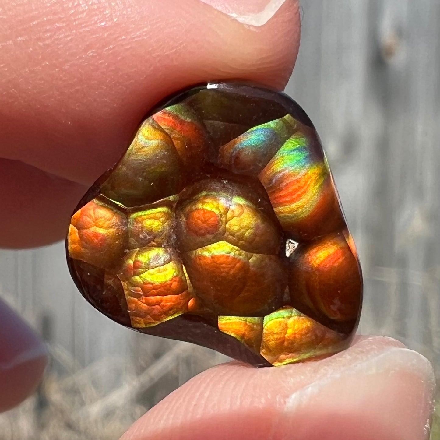 A freeform shaped Mexican fire agate stone.  The stone is red with yellow banding.