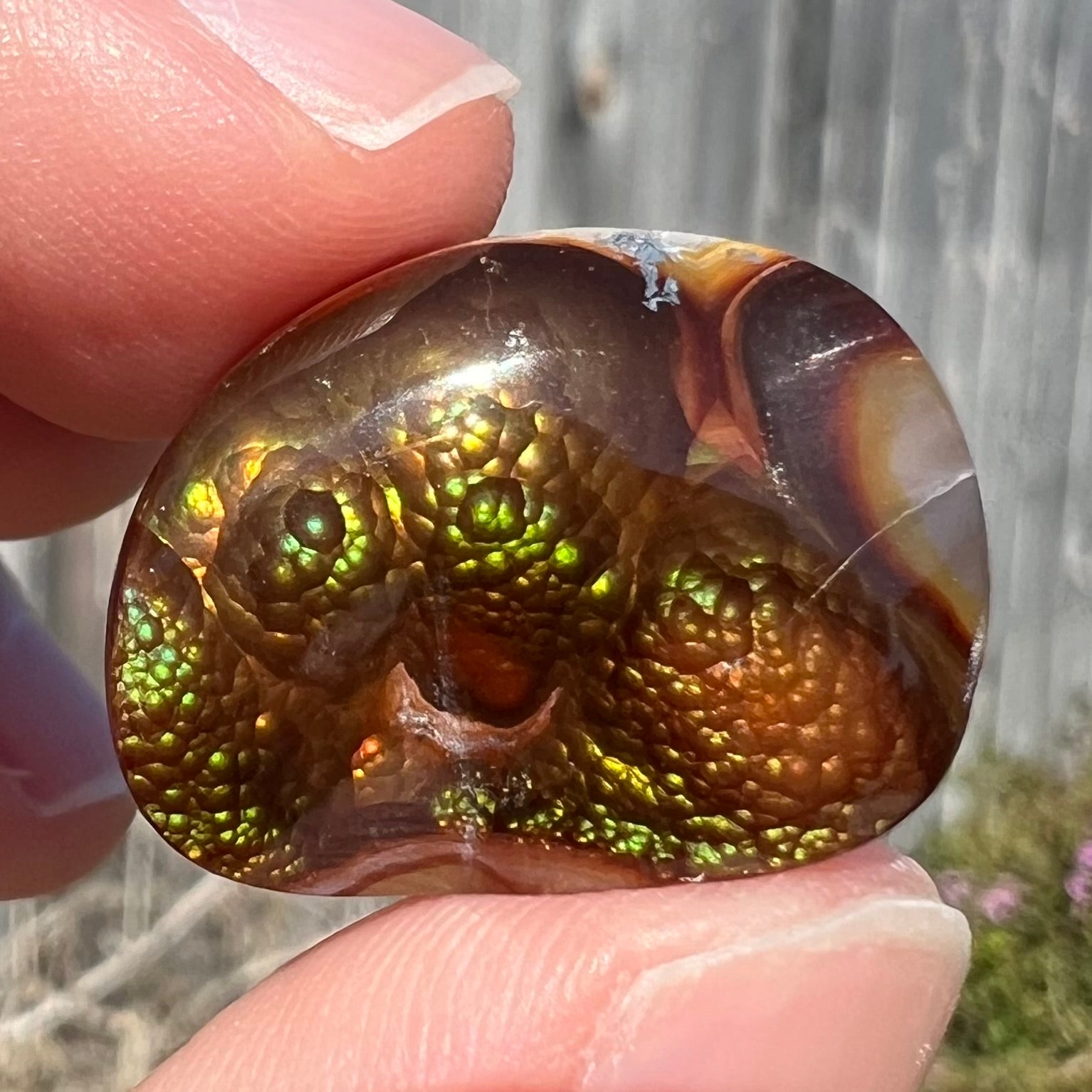 A large Mexican fire agate cabochon.  The stone has a bubbly green pattern.