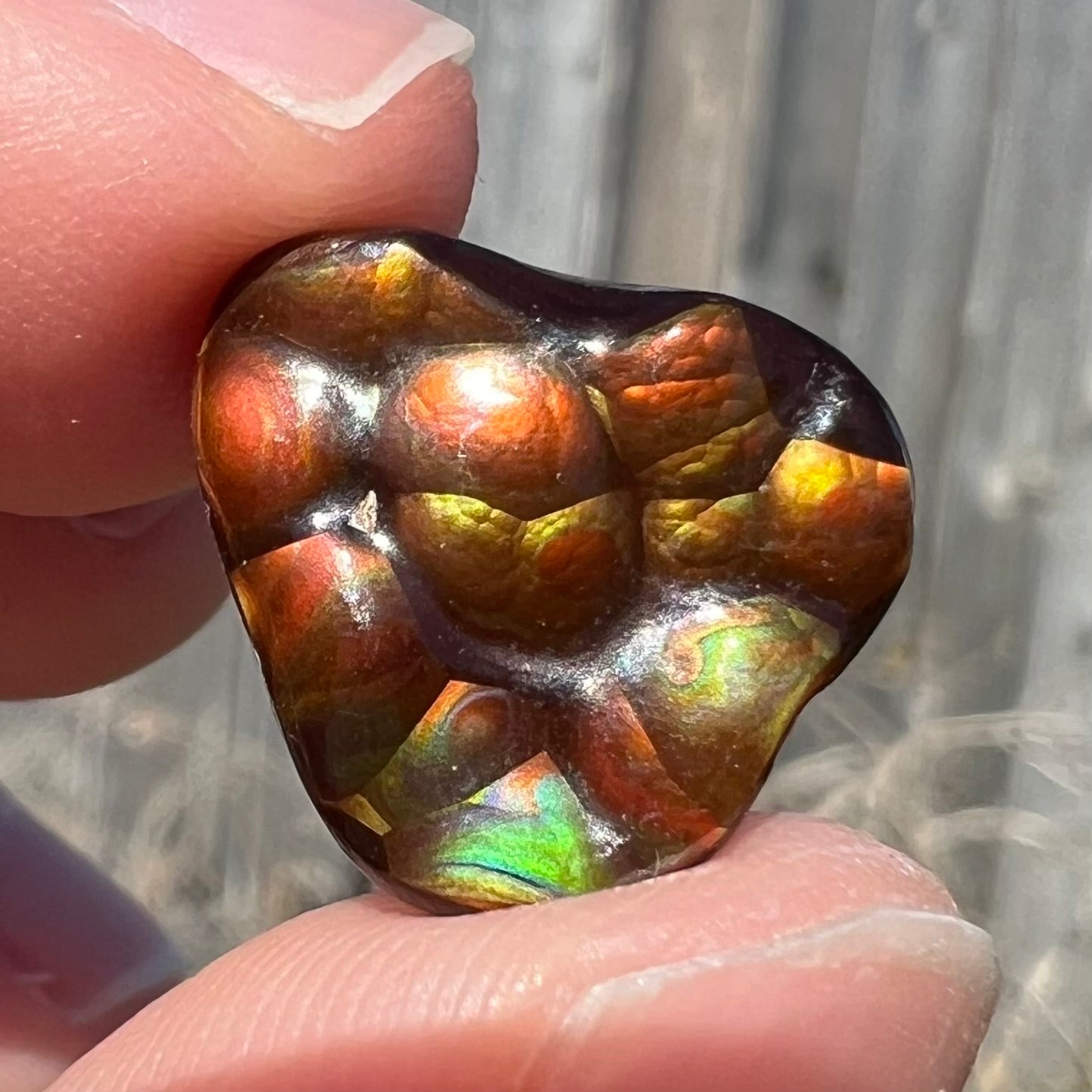 A freeform shaped Mexican fire agate stone.  The stone is red with yellow banding.