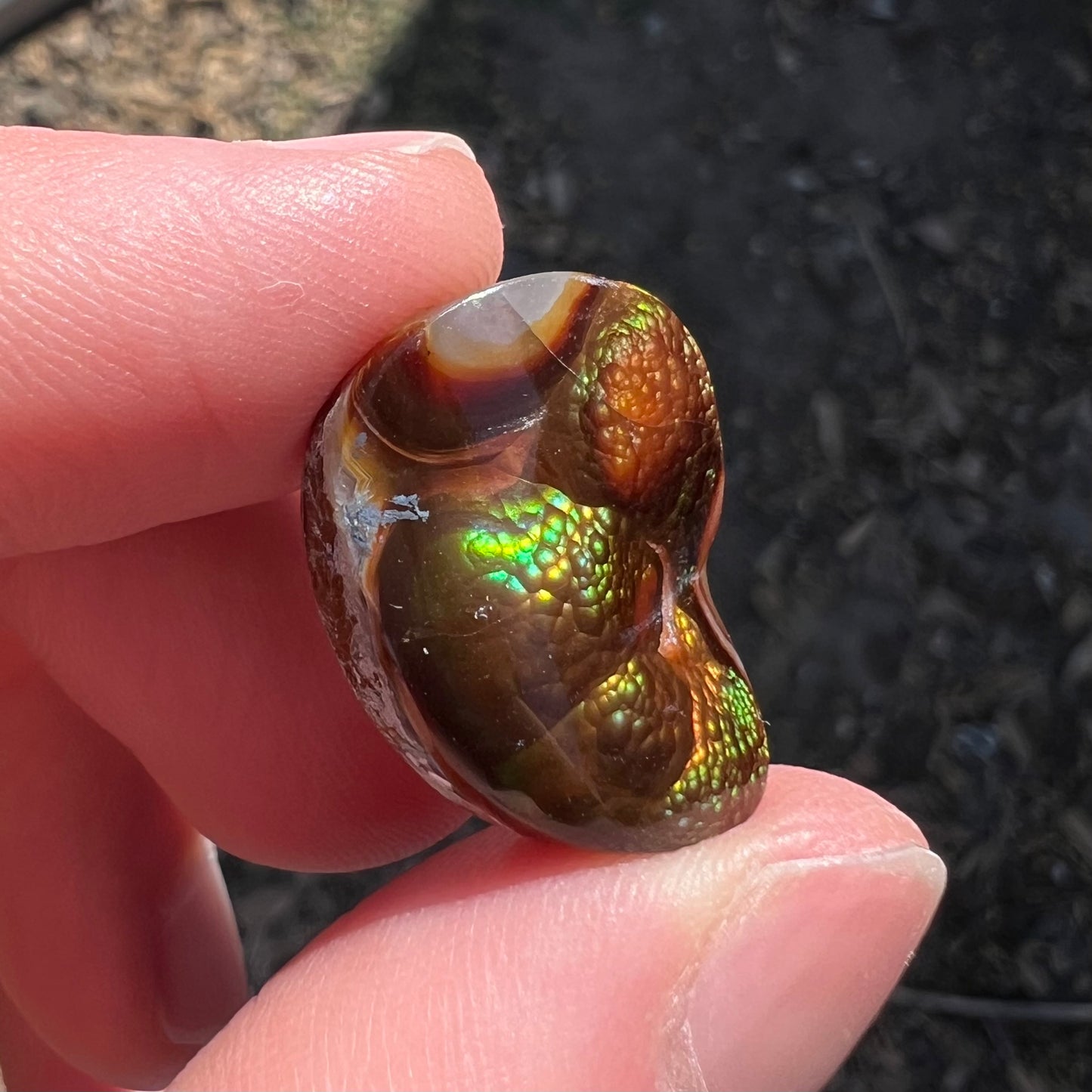 A large Mexican fire agate cabochon.  The stone has a bubbly green pattern.