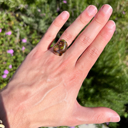 A large Mexican fire agate cabochon.  The stone has a bubbly green pattern.