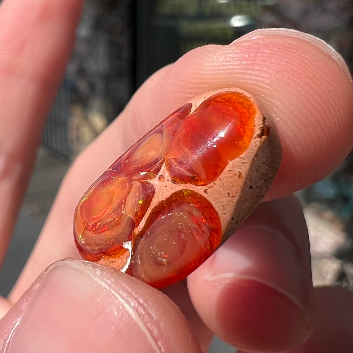 A loose Mexican matrix fire opal stone.  The opal is orange with green flashes.