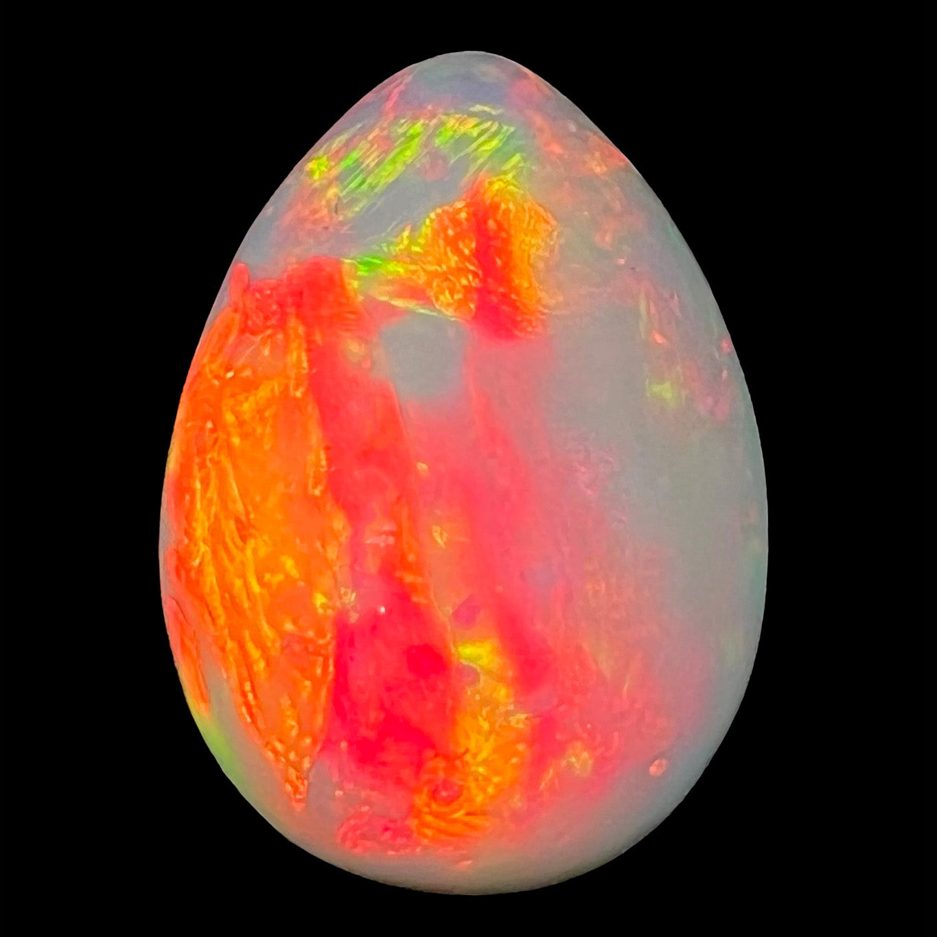 A pear shaped Ethiopian fire opal with vivid red and green play of color.