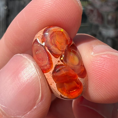 A loose Mexican matrix fire opal stone.  The opal is orange with green flashes.