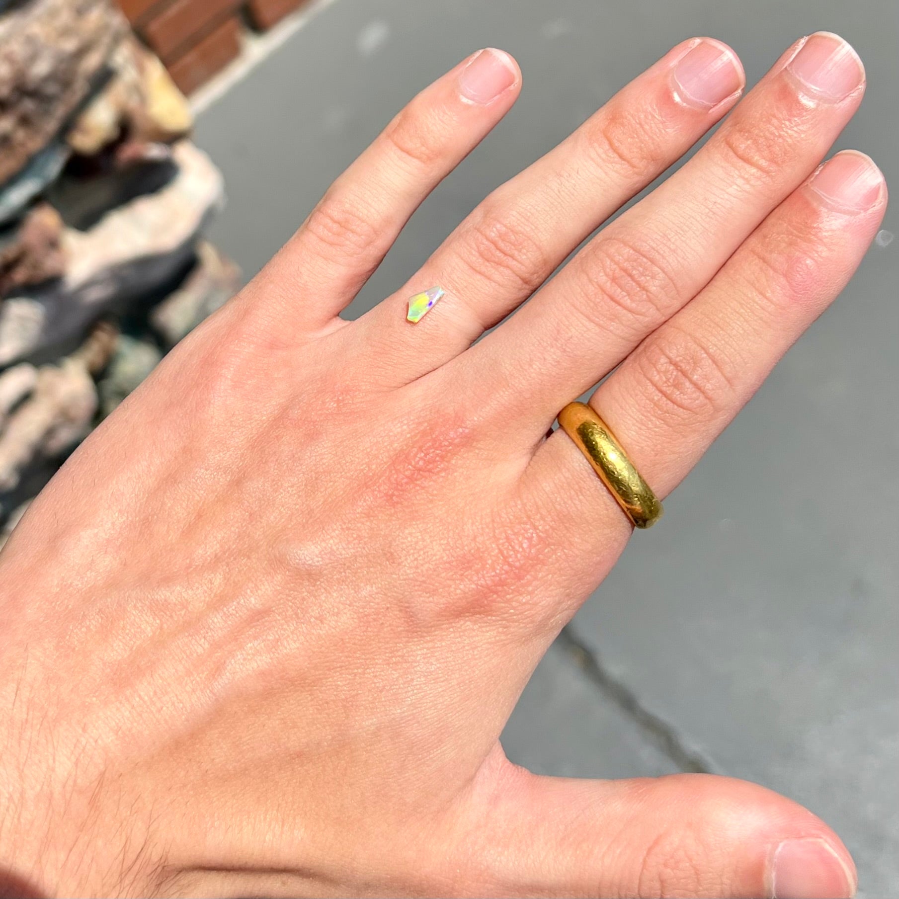 A loose, Australian fire opal chip.  The stone shines red, green, and yellow colors.