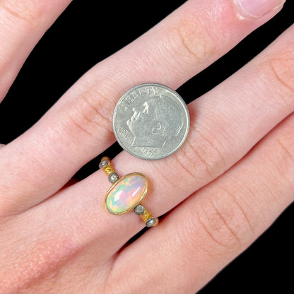 A yellow gold plated sterling silver ring mounted with an Ethiopian fire opal and rose cut diamond accents.