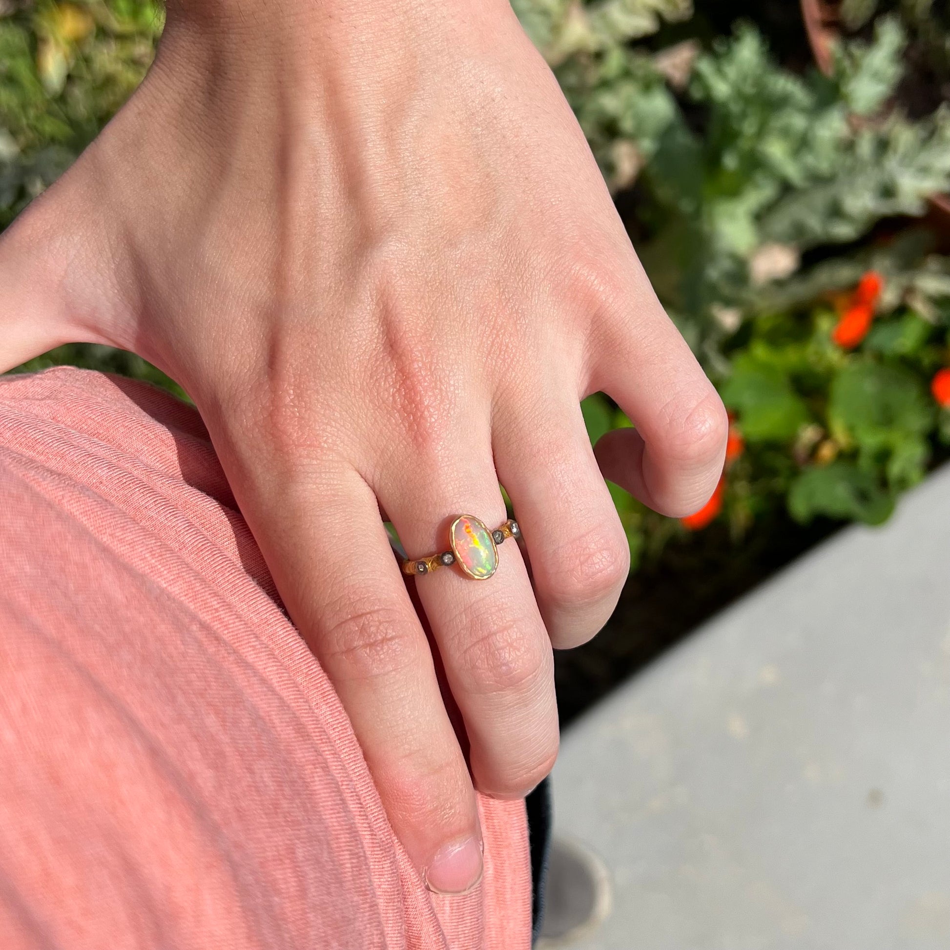 A yellow gold plated sterling silver ring mounted with an Ethiopian fire opal and rose cut diamond accents.