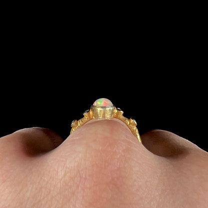 A yellow gold plated sterling silver ring mounted with an Ethiopian fire opal and rose cut diamond accents.