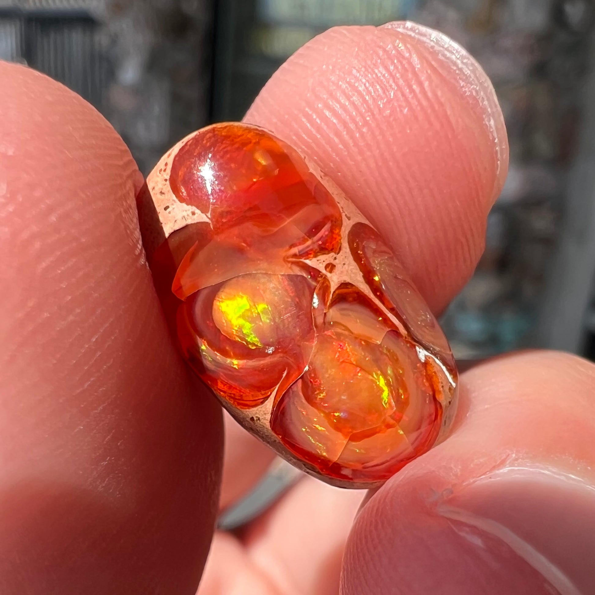 A loose Mexican matrix fire opal stone.  The opal is orange with green flashes.