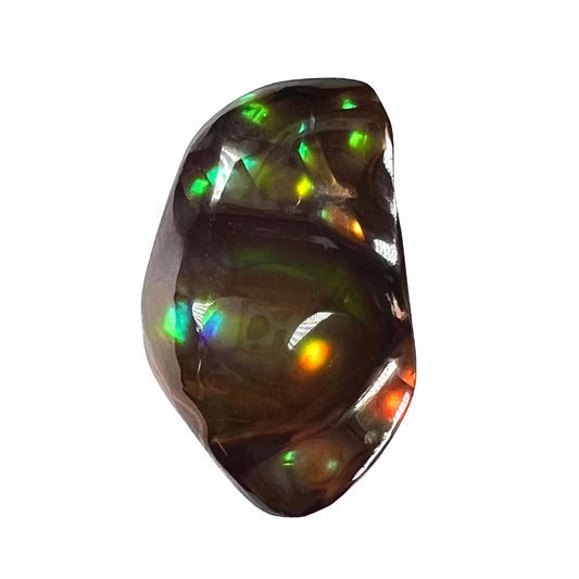 A loose fire agate stone.  The stone has a rainbow of metallic iridescence.