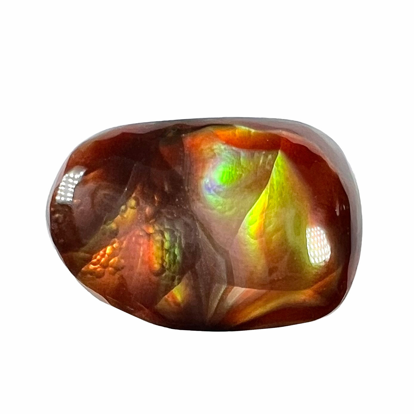 A loose fire agate cabochon.  The stne shows green and orange iridescence on a brown body tone.