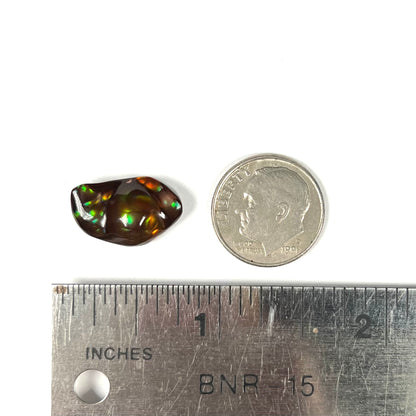 A loose fire agate stone.  The stone has a rainbow of metallic iridescence.