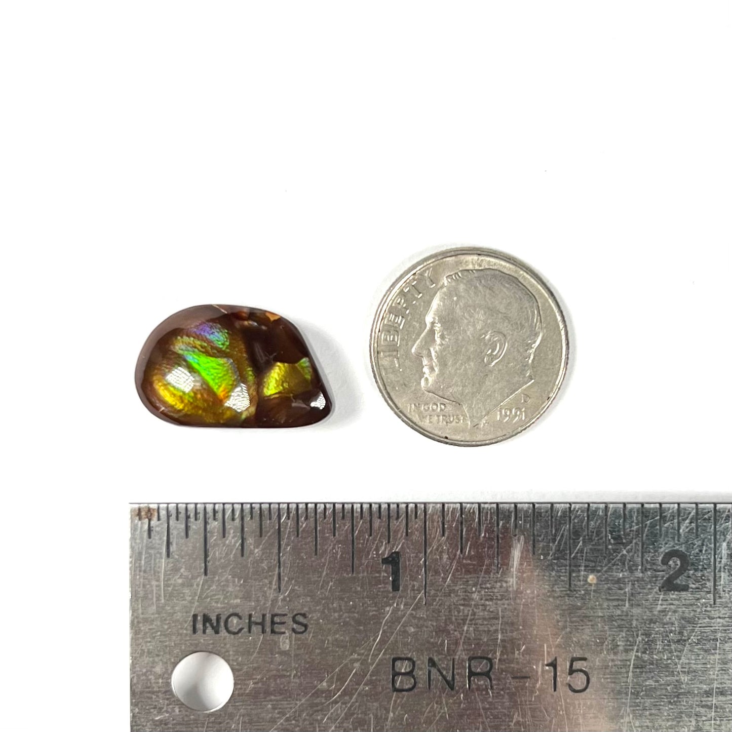 A brightly reflective Mexican fire agate cabochon.  The stone has a strong green iridescence.