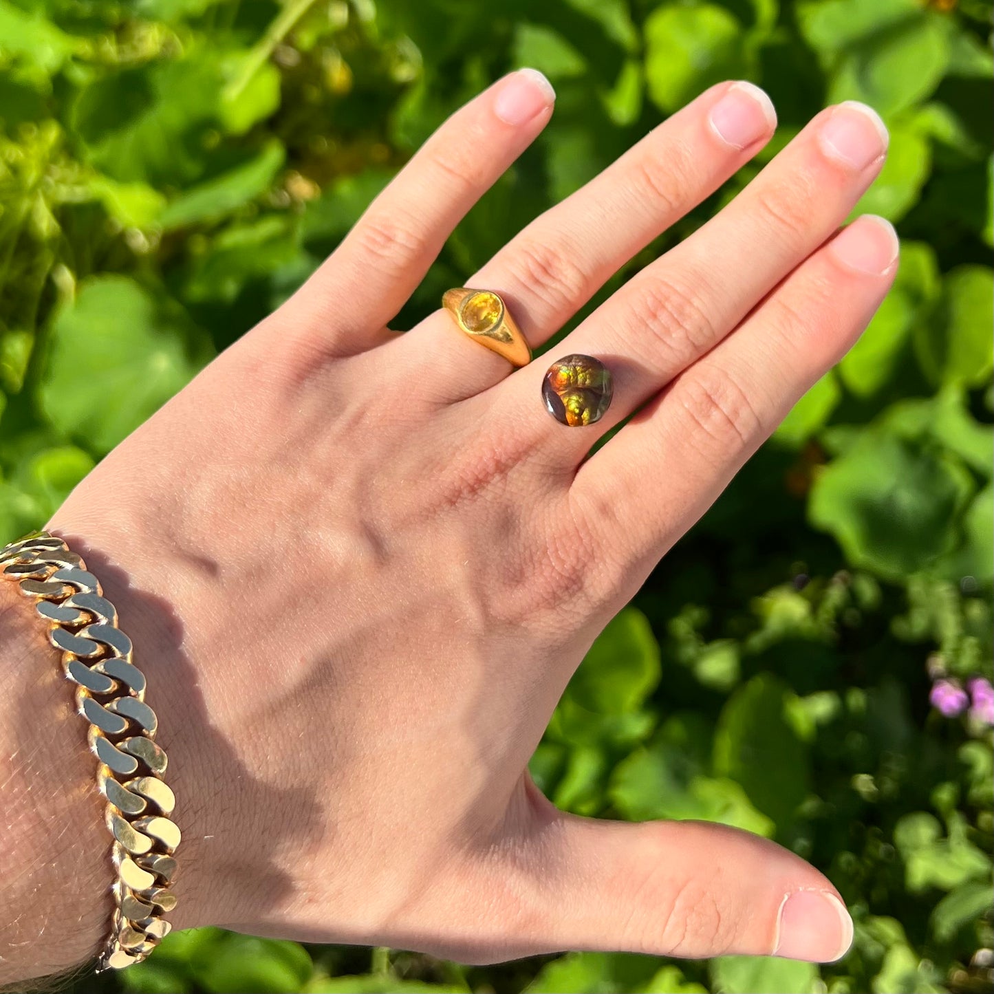 A loose, round Mexican fire agate stone.  The stone shines colors of green, yellow, and orange.