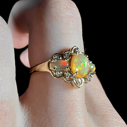 A three-stone gold ring set with Ethiopian fire opals and diamond accents.