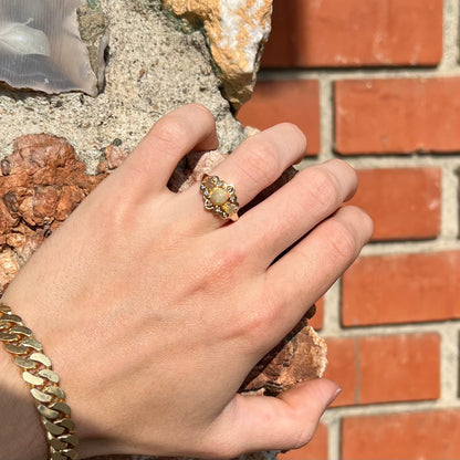 A three-stone gold ring set with Ethiopian fire opals and diamond accents.