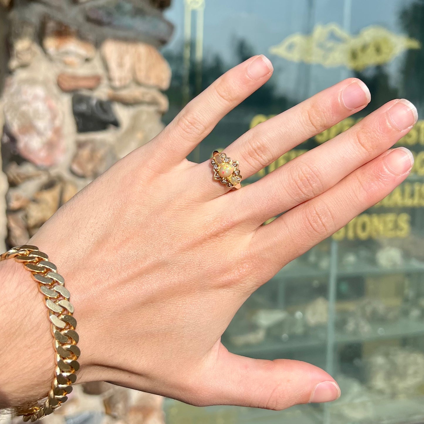 A three-stone gold ring set with Ethiopian fire opals and diamond accents.