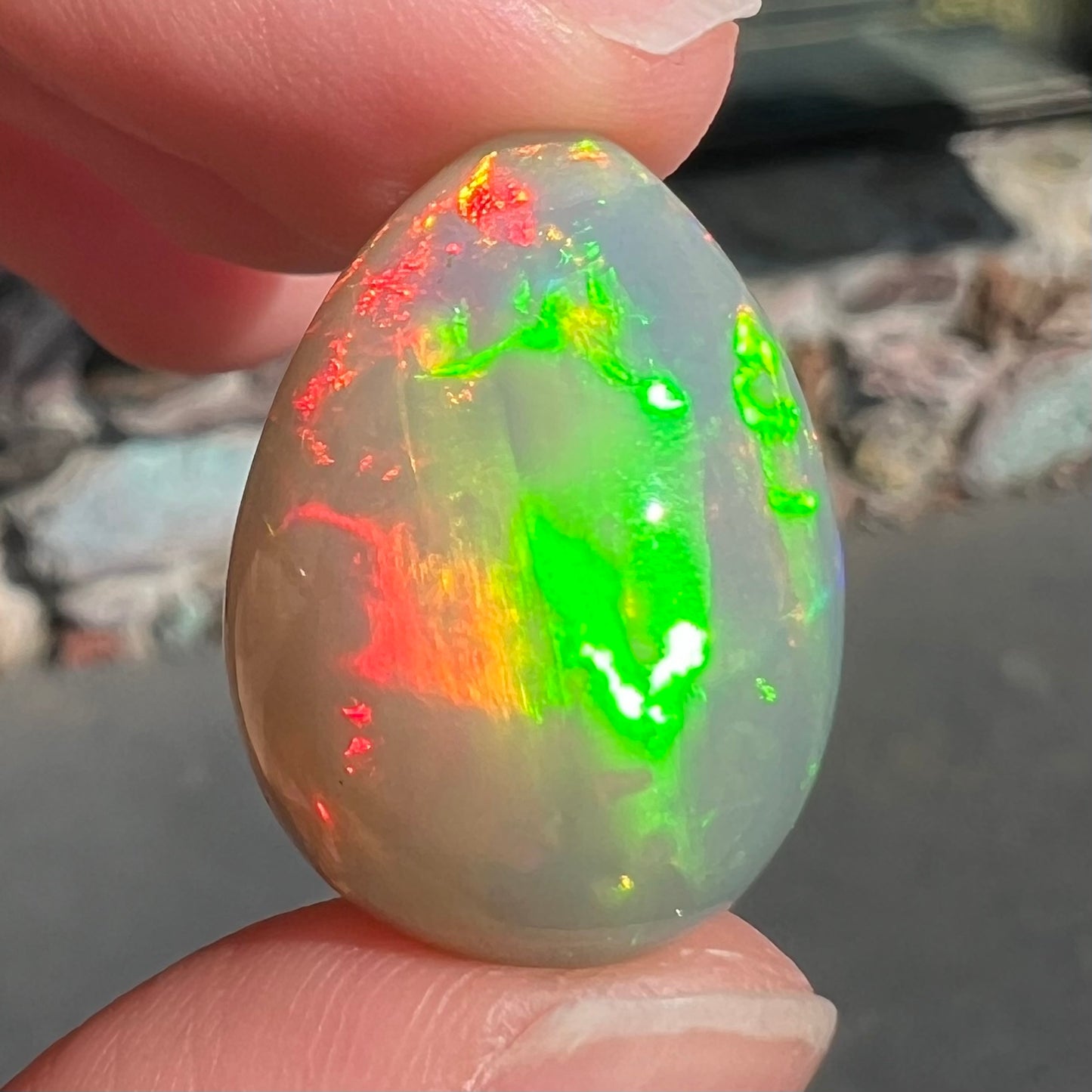 A pear shaped Ethiopian fire opal with vivid red and green play of color.