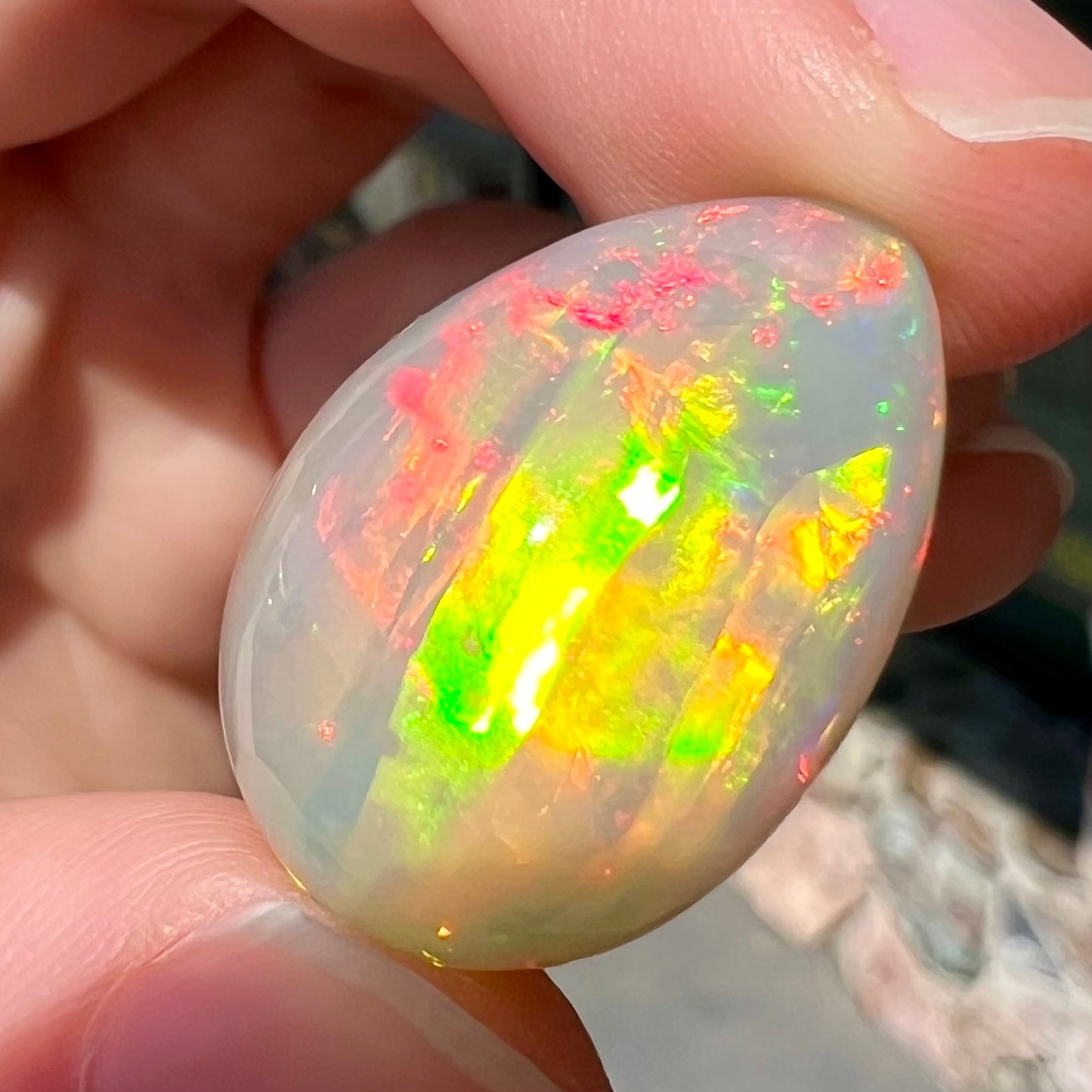 A pear shaped Ethiopian fire opal with vivid red and green play of color.