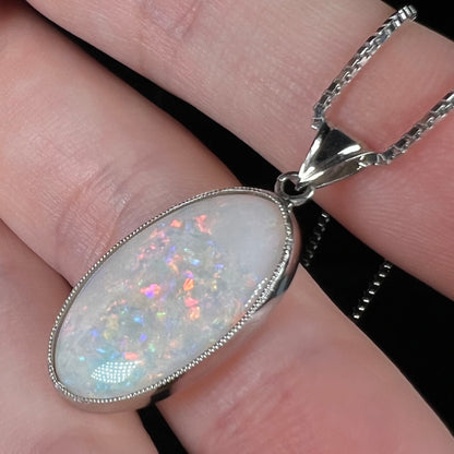 A platinum pendant mounted with an oval cut Australian white opal.