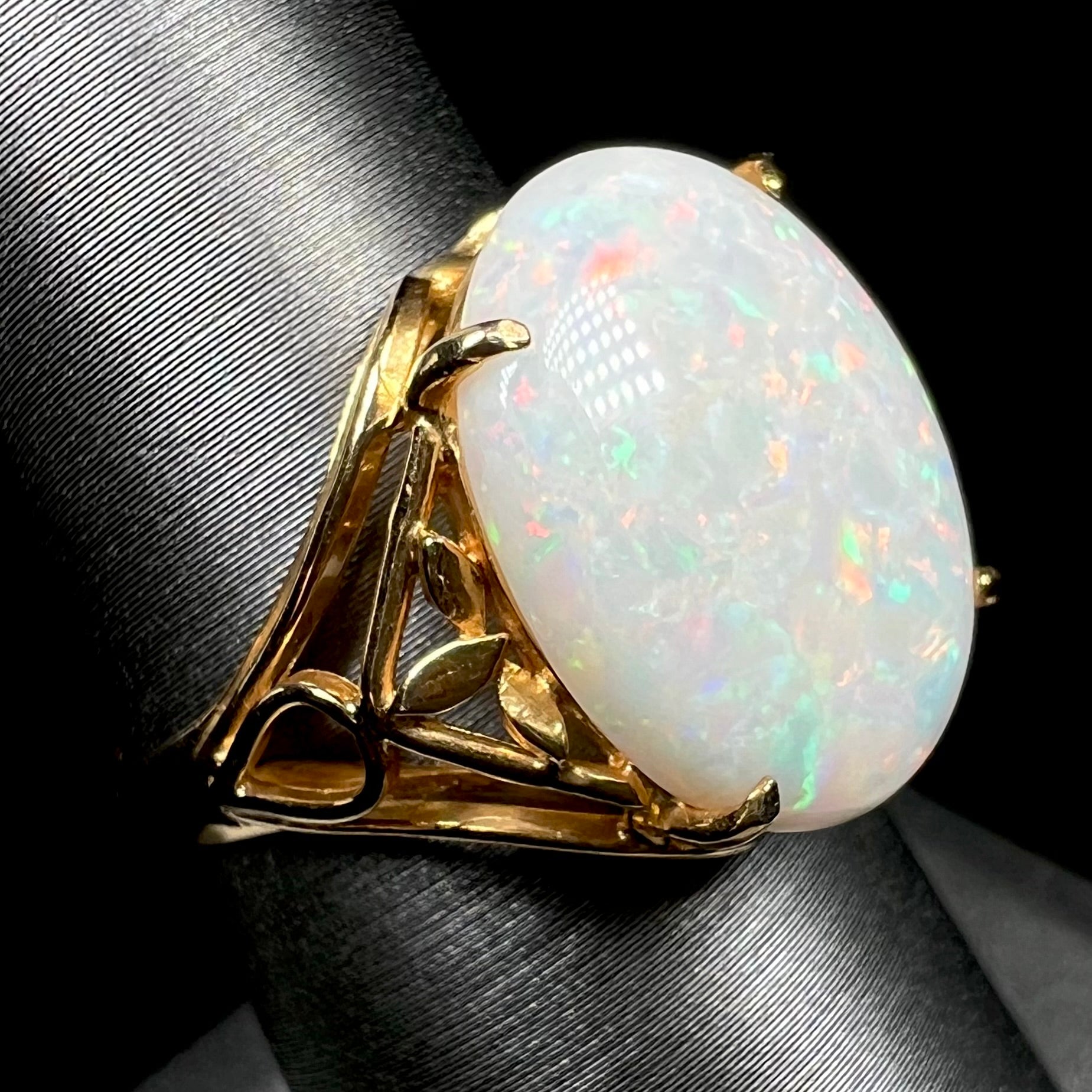 A yellow gold solitaire cocktail ring mounted with a natural white opal from Coober Pedy, Australia.