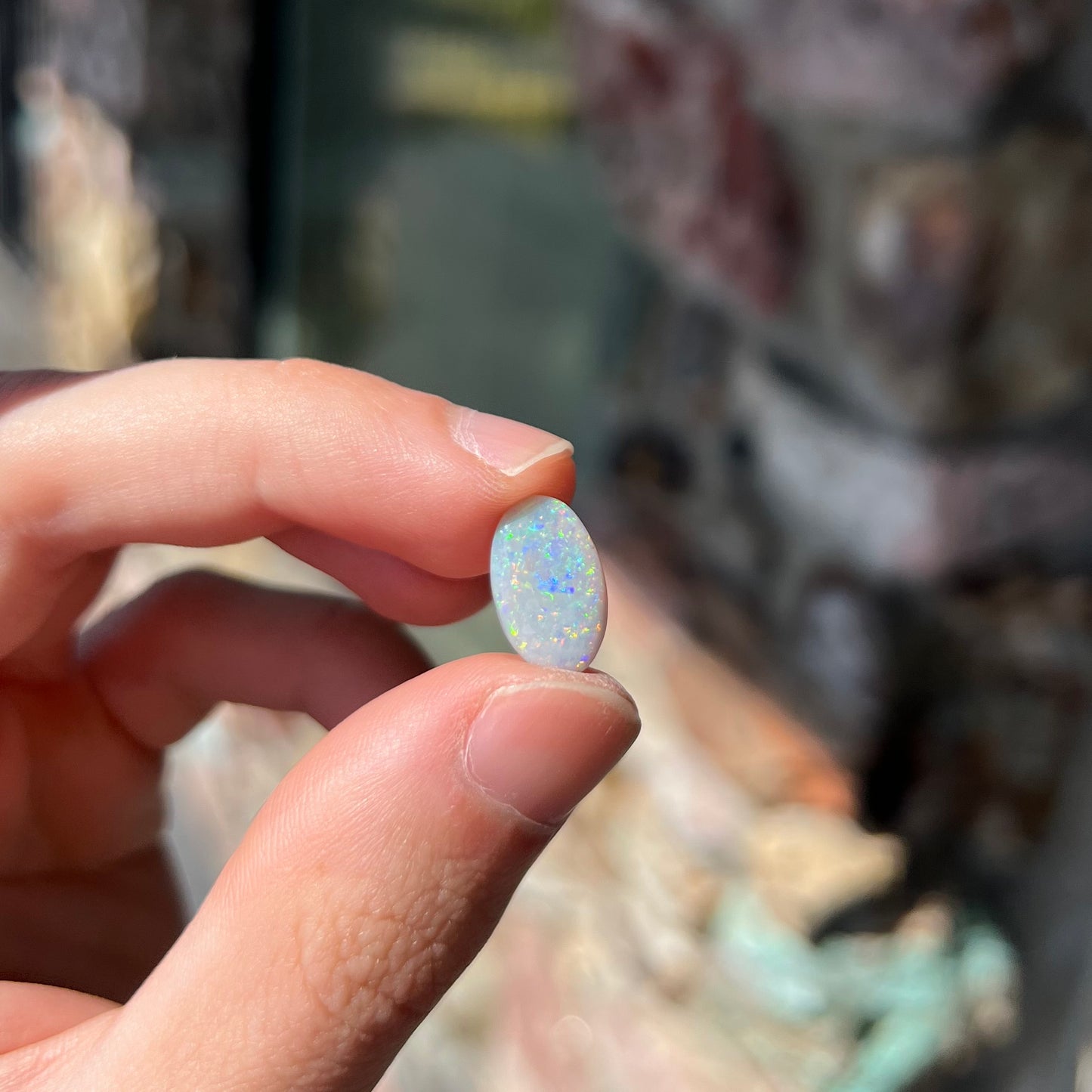 A semi-black, small flashfire opal stone from Mintabie, Australia.