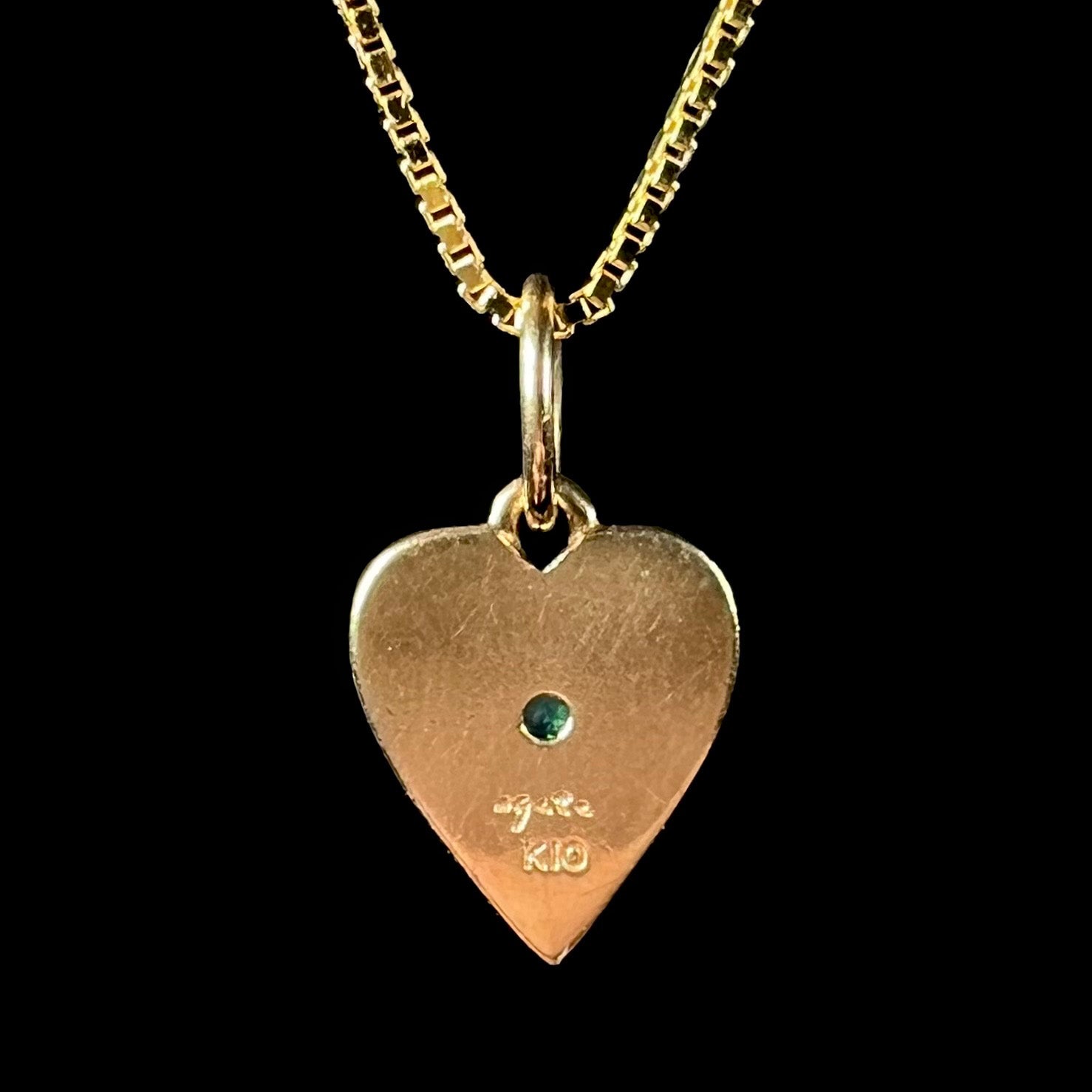 A yellow gold filigree heart necklace set with a round Australian crystal opal.  The opal has green fire.