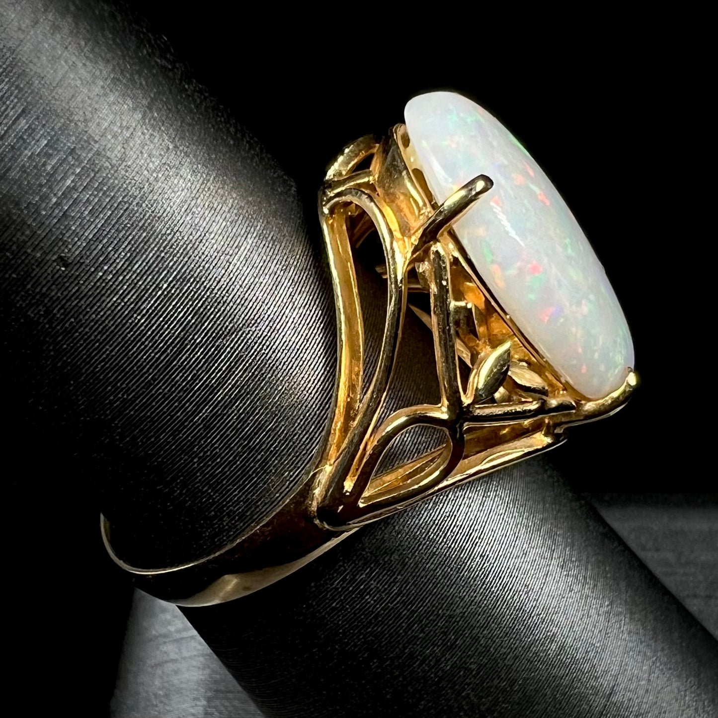 A yellow gold solitaire cocktail ring mounted with a natural white opal from Coober Pedy, Australia.