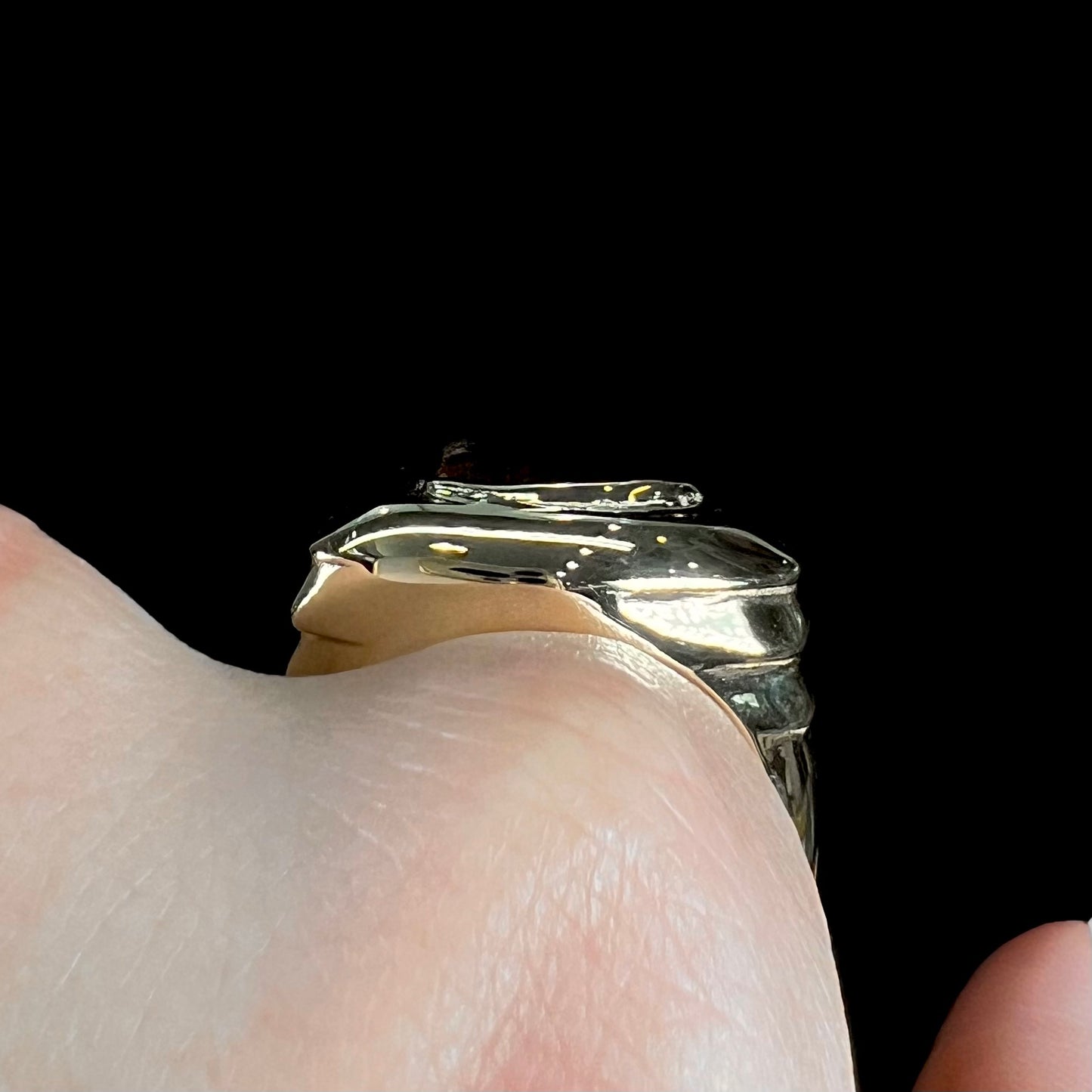 A custom, solid yellow gold men's ring.