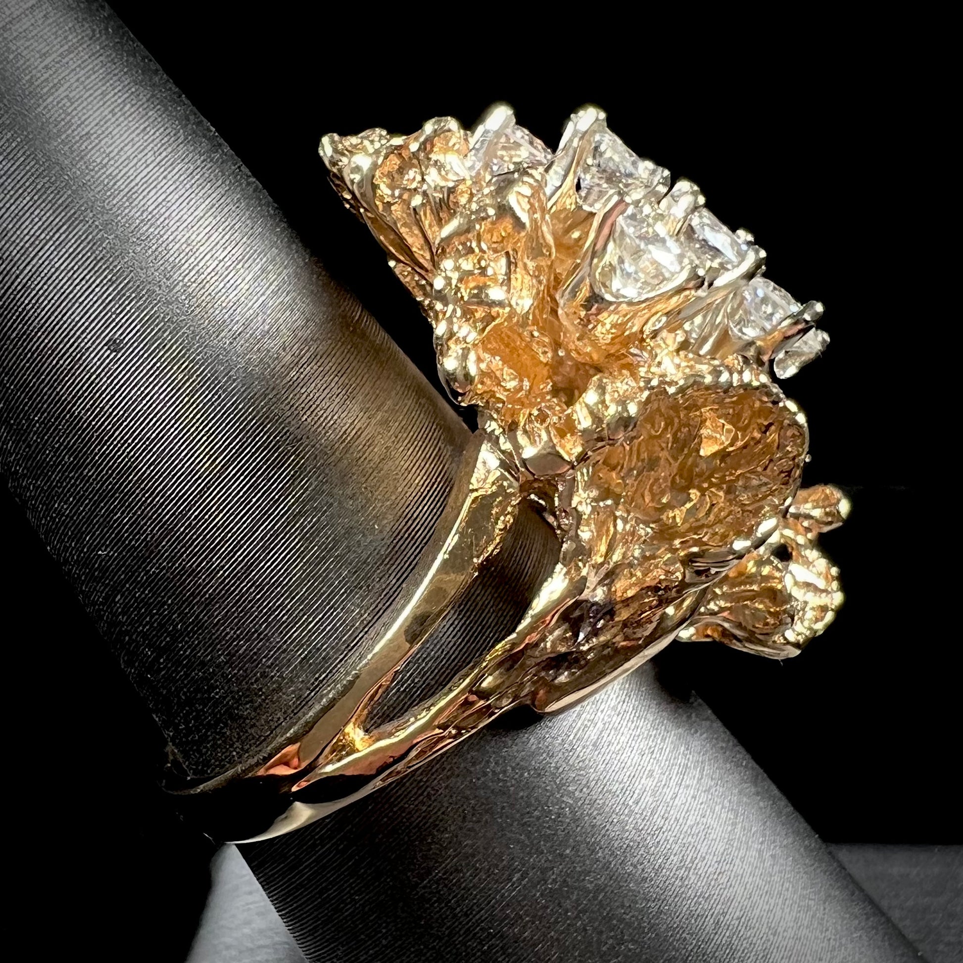 A ladies' 1950's style yellow gold and diamond cluster ring.  The ring is shaped like a leaf with 10 round diamonds set in it.