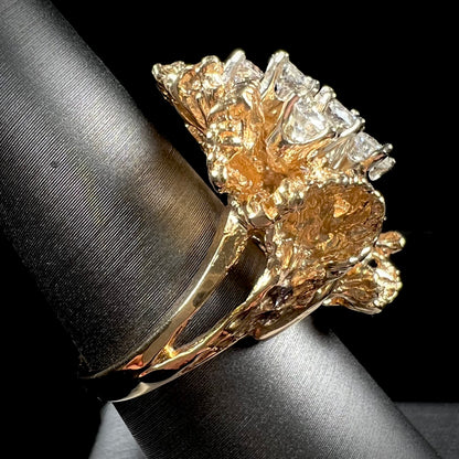 A ladies' 1950's style yellow gold and diamond cluster ring.  The ring is shaped like a leaf with 10 round diamonds set in it.