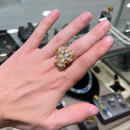 A ladies' 1950's style yellow gold and diamond cluster ring.  The ring is shaped like a leaf with 10 round diamonds set in it.