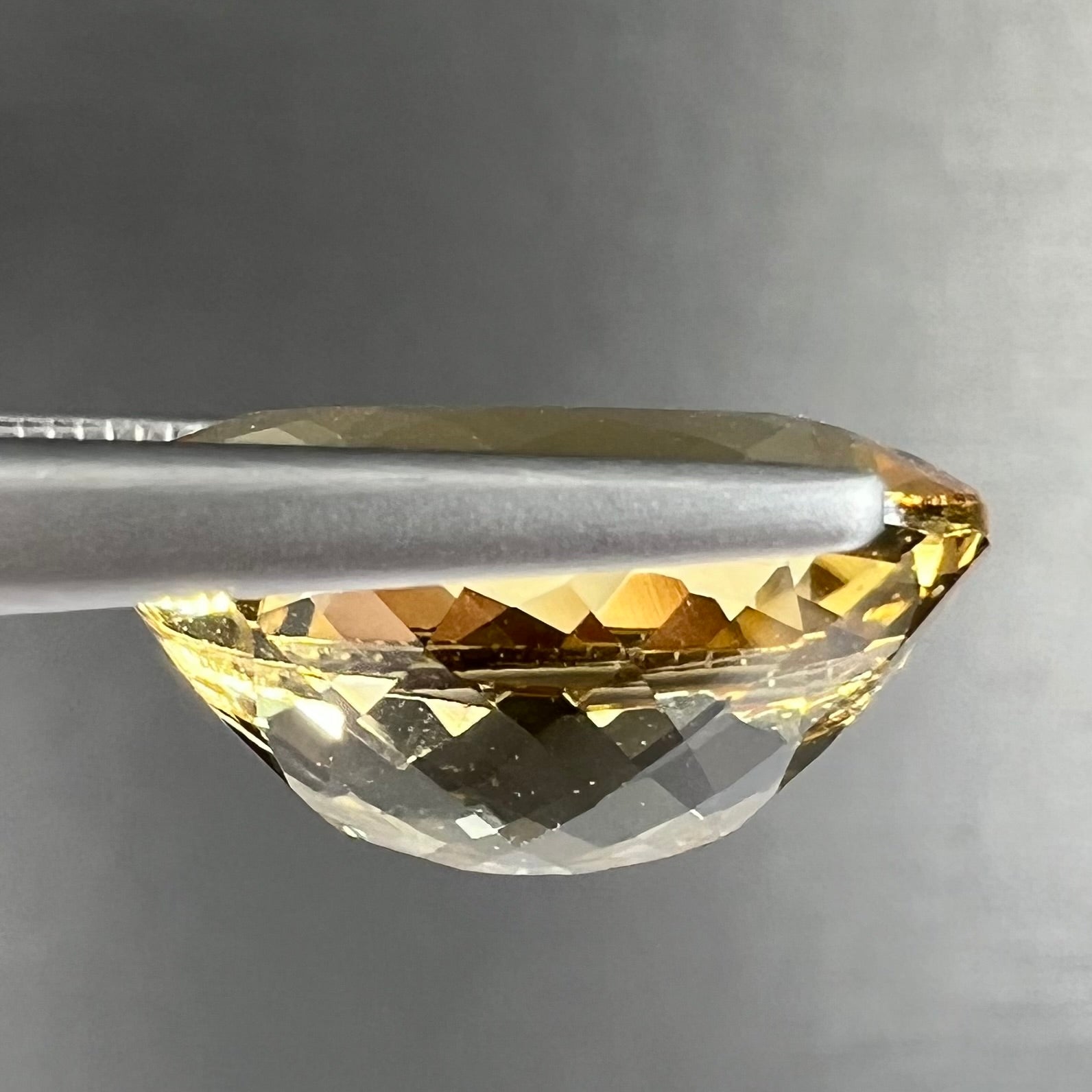 A faceted, oval cut golden beryl gemstone.