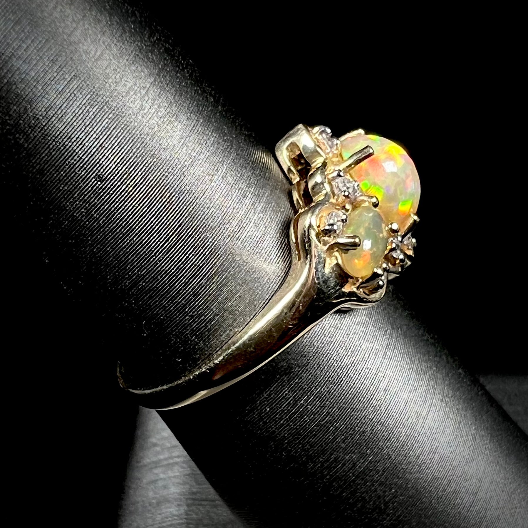 A three-stone gold ring set with Ethiopian fire opals and diamond accents.