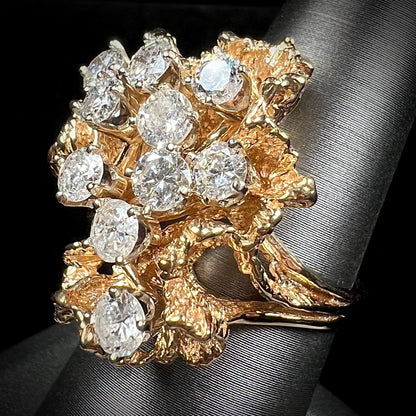 A ladies' 1950's style yellow gold and diamond cluster ring.  The ring is shaped like a leaf with 10 round diamonds set in it.