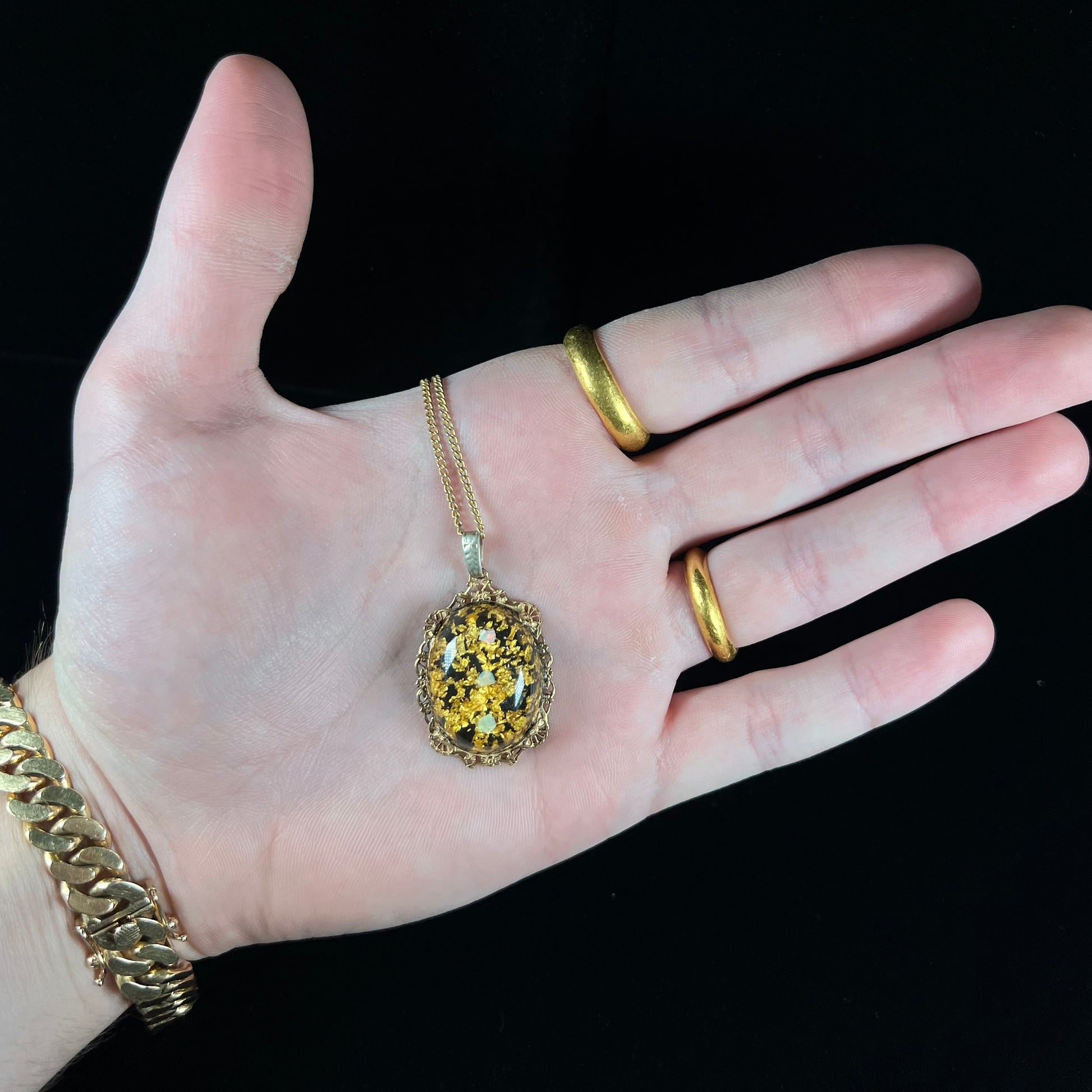 A vintage gold filled filigree necklace set with three rough opal crystals and gold leaf flakes.