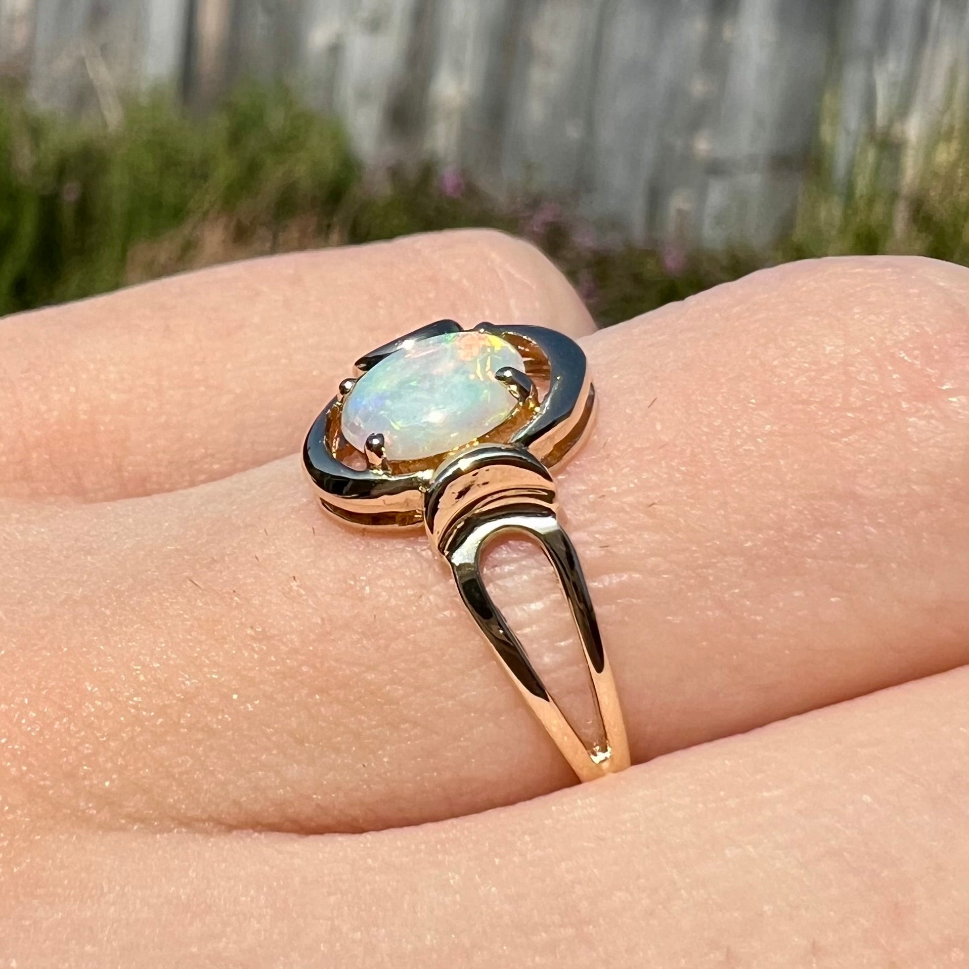 A 14 karat yellow gold open-shank design Australian crystal opal ring.