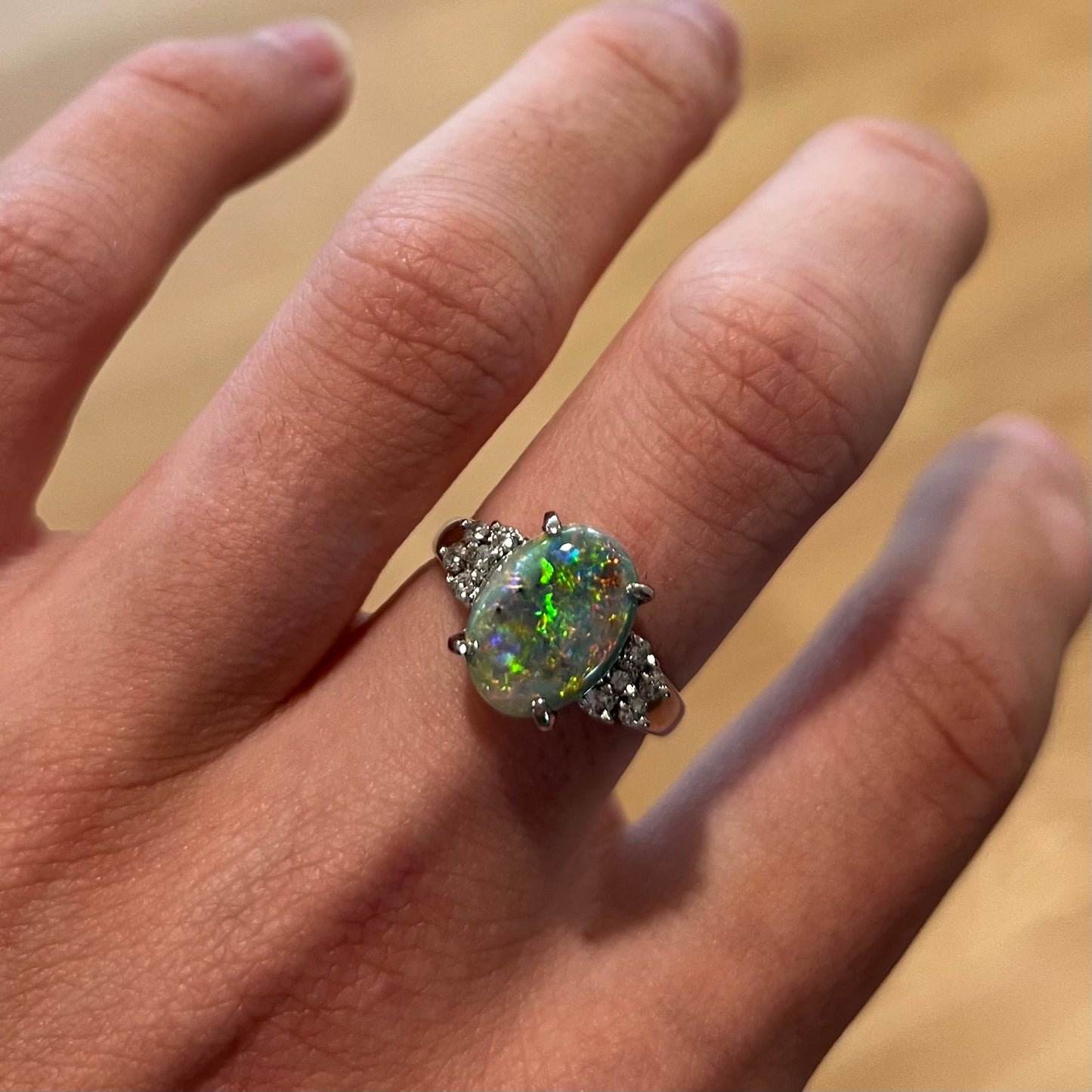 A multicolor Lightning Ridge opal and diamond-accented ring in platinum.