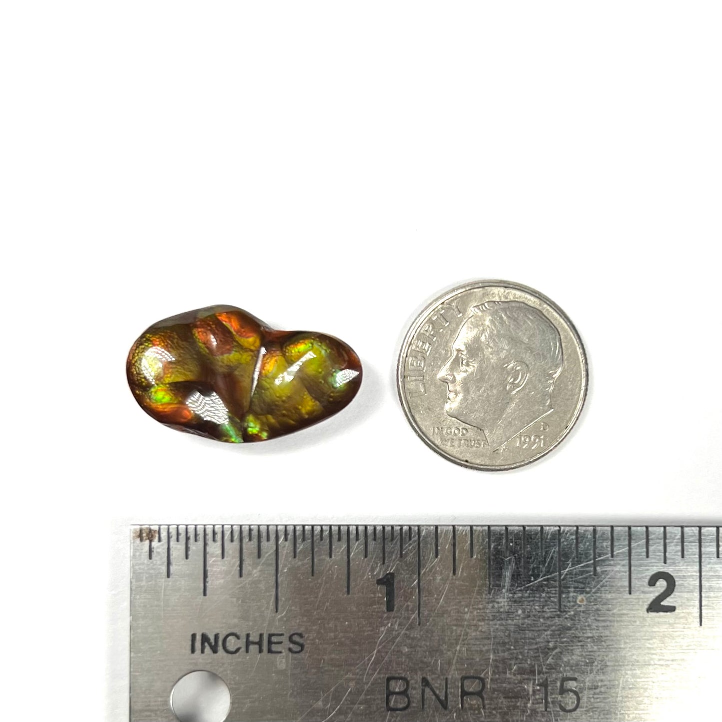 A loose, freeform shaped Mexican fire agate.  The stone has green and orange iridescence.