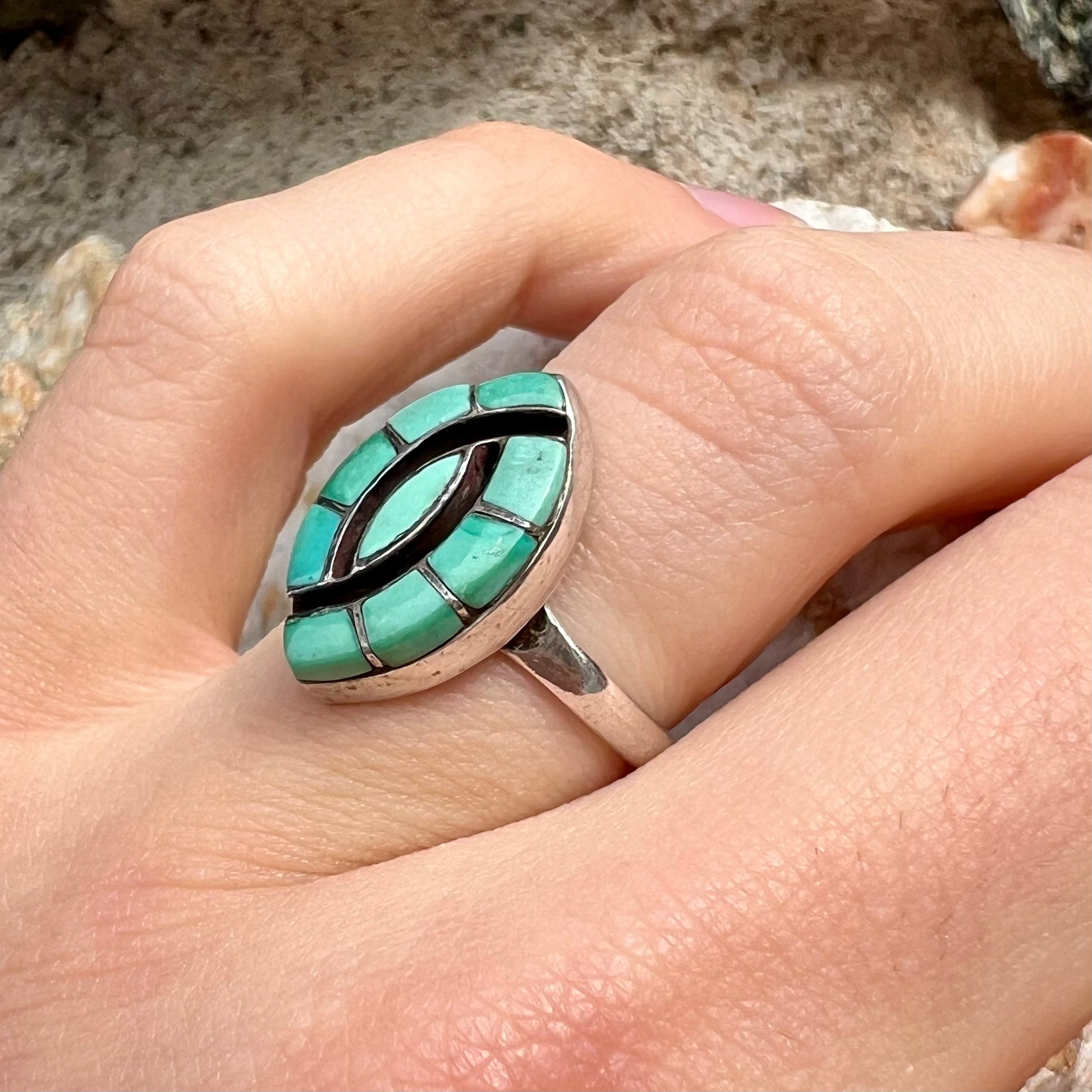 Vintage sterling silver Zuni Indian ring inlay set with green turquoise stones in the motif of a hummingbird.