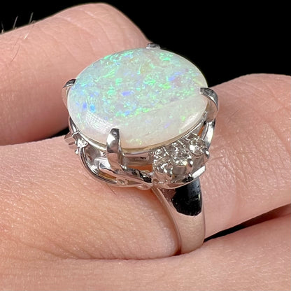 A round cut Australian opal and diamond engagment ring with platinum filigree.