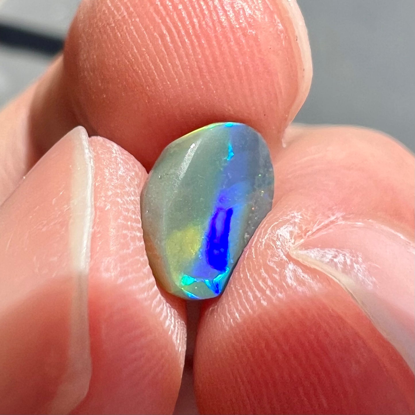 A loose, oval cut black opal from Lighting Ridge, Australia.  The stone is highly directional.