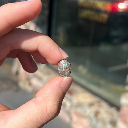 A loose, oval cabochon cut matrix opal stone from Honduras.