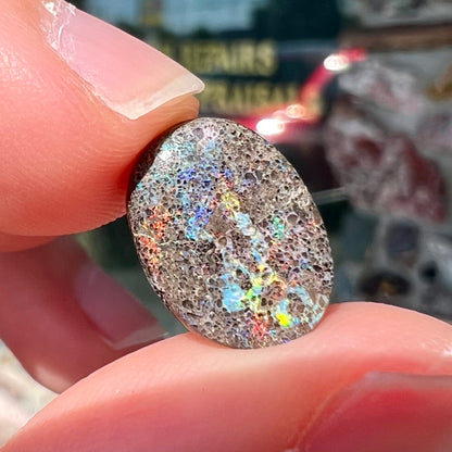 A loose, oval cabochon cut matrix opal stone from Honduras.