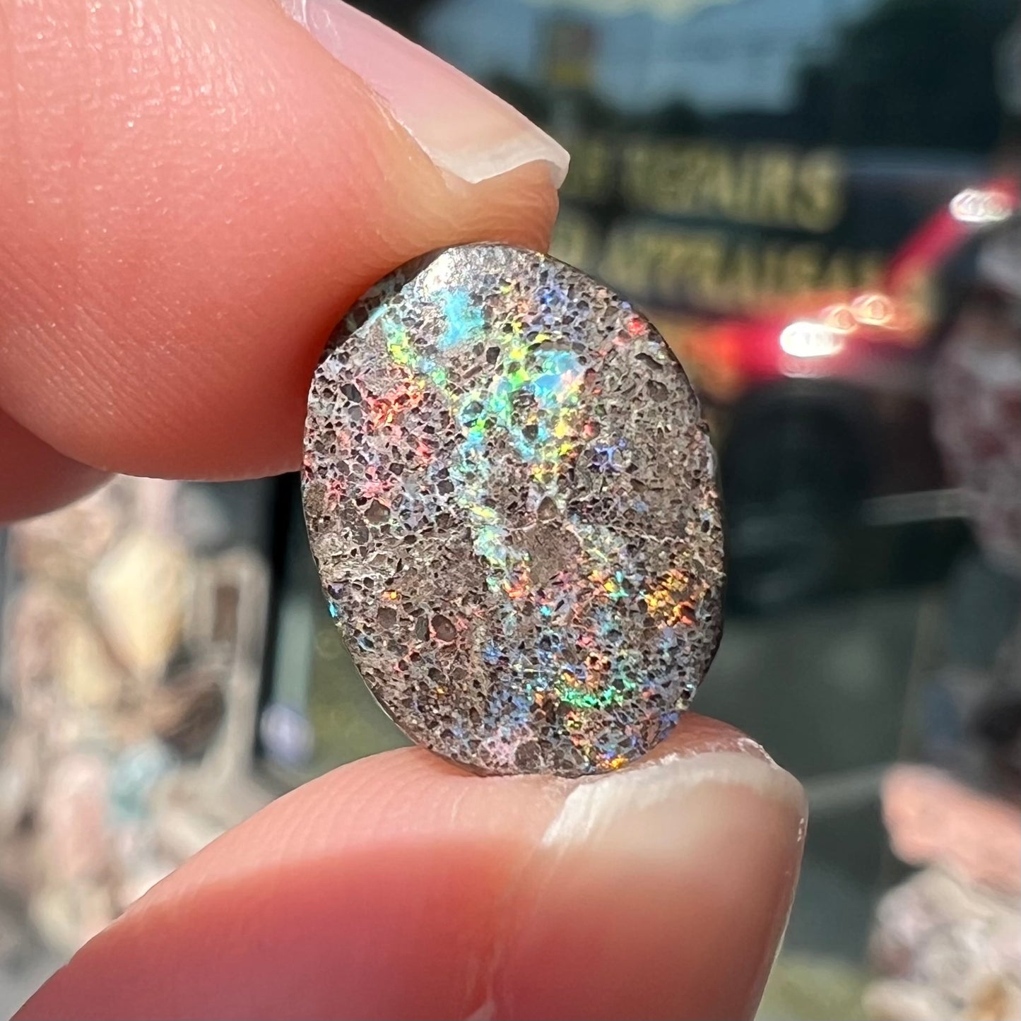 A loose, oval cabochon cut matrix opal stone from Honduras.