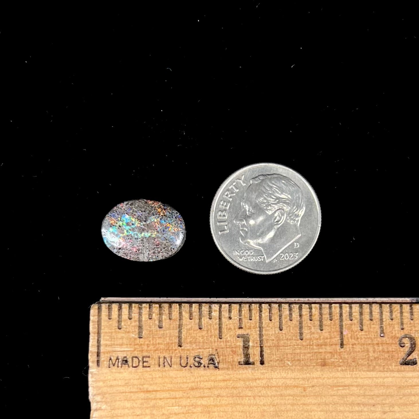 A loose, oval cabochon cut matrix opal stone from Honduras.