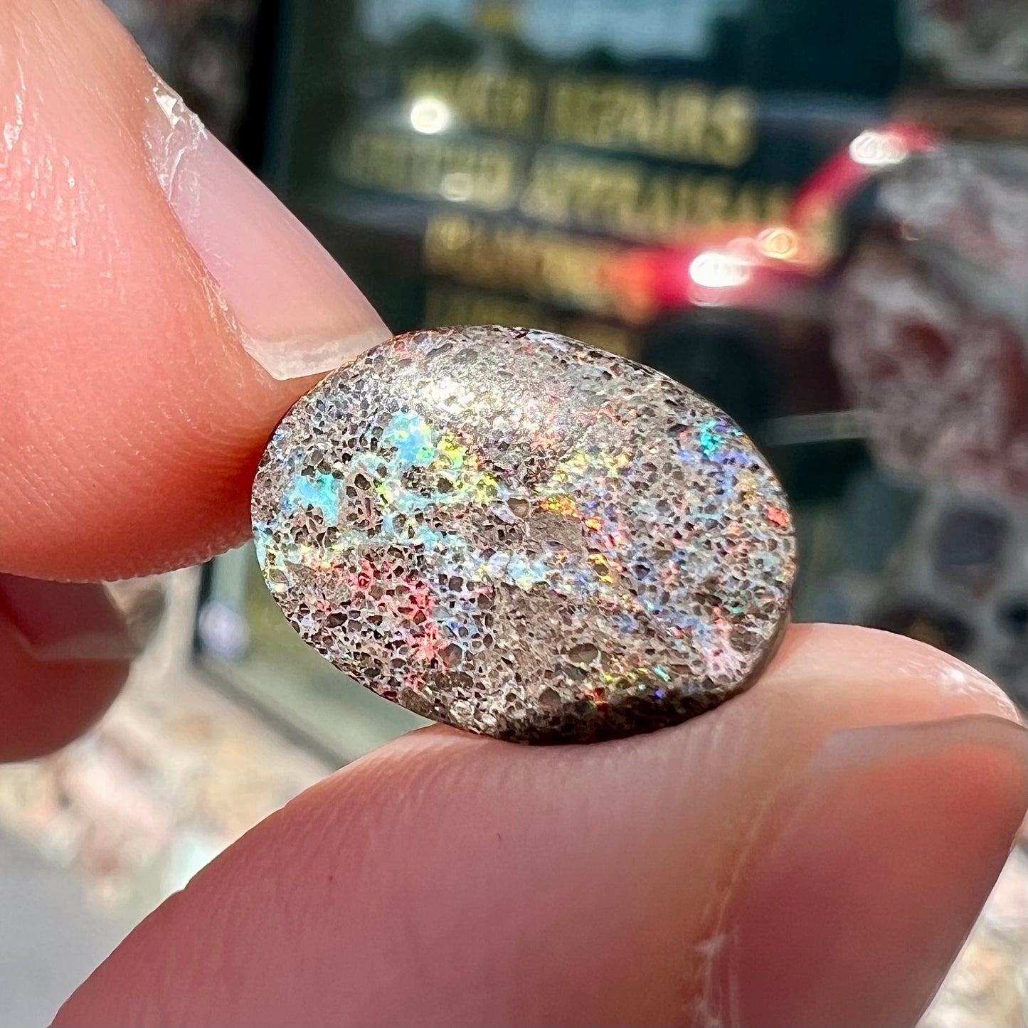 A loose, oval cabochon cut matrix opal stone from Honduras.