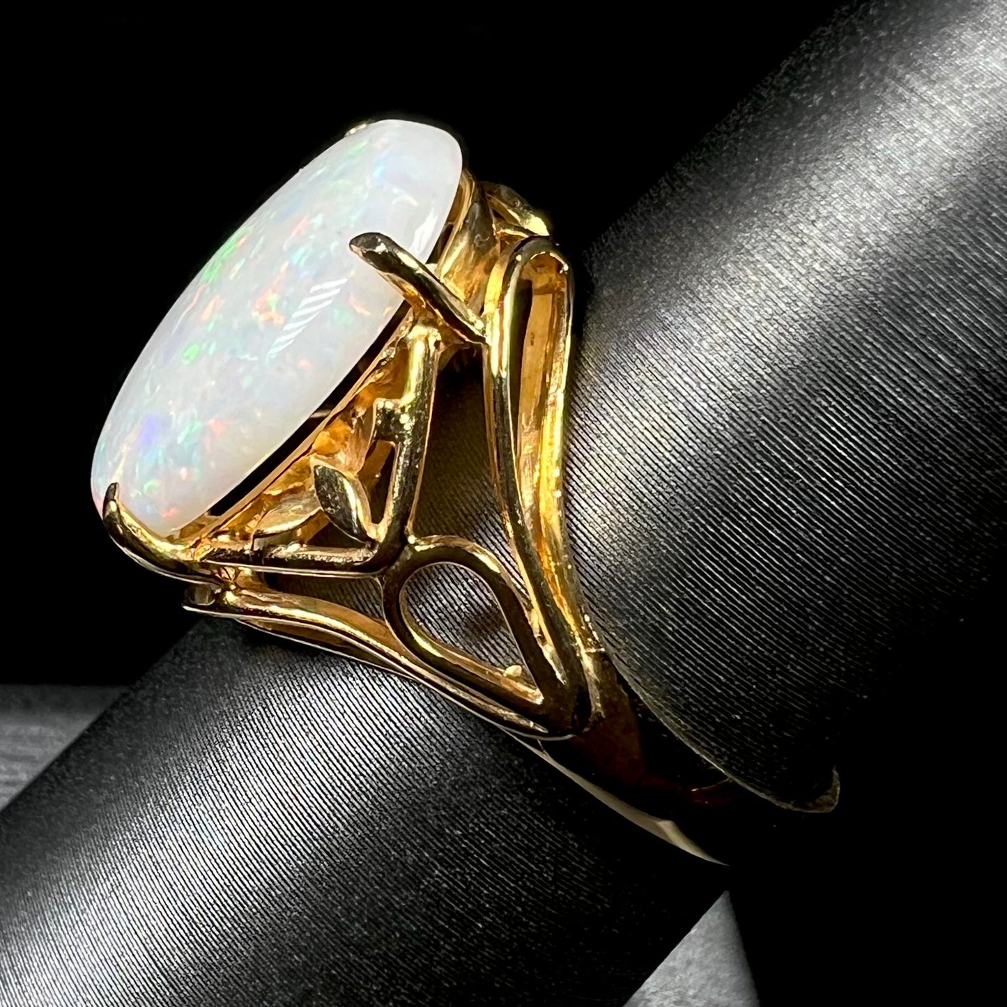 A yellow gold solitaire cocktail ring mounted with a natural white opal from Coober Pedy, Australia.